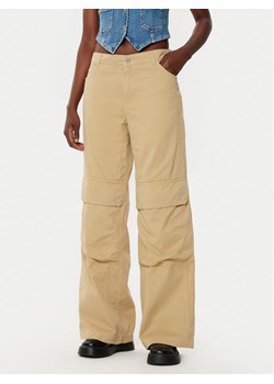 HUGO Spodnie materiałowe Hunder 50530833 Beżowy Relaxed Fit ze sklepu MODIVO w kategorii Spodnie damskie - zdjęcie 182699166