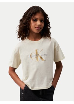 Calvin Klein Jeans T-Shirt Glitter Monogram IG0IG02529 Écru Boxy Fit ze sklepu MODIVO w kategorii Bluzki dziewczęce - zdjęcie 182705206