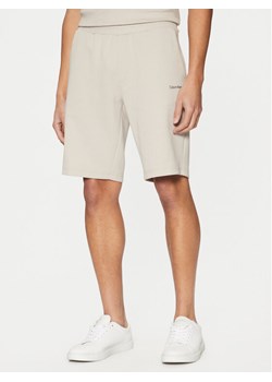 Calvin Klein Szorty sportowe Micro Logo K10K111208 Beżowy Regular Fit ze sklepu MODIVO w kategorii Spodenki męskie - zdjęcie 182707557