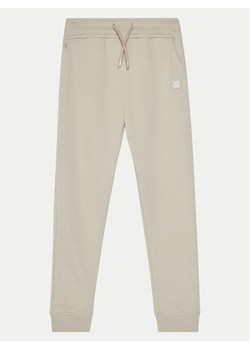 Calvin Klein Jeans Spodnie dresowe IU0IU00621 Beżowy Regular Fit ze sklepu MODIVO w kategorii Spodnie dziewczęce - zdjęcie 182707837