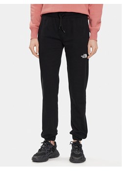 The North Face Spodnie dresowe Standard NF0A5ID4 Czarny Regular Fit ze sklepu MODIVO w kategorii Spodnie damskie - zdjęcie 182715789