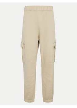 Champion Spodnie dresowe 117554 Beżowy Loose Fit ze sklepu MODIVO w kategorii Spodnie damskie - zdjęcie 182717629