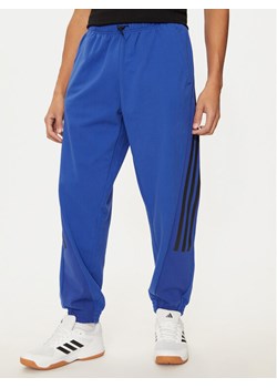 adidas Spodnie dresowe Future Icons 3-Stripes Polar IV5131 Niebieski Regular Fit ze sklepu MODIVO w kategorii Spodnie męskie - zdjęcie 182717779