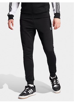 adidas Spodnie dresowe adicolor Classics SST IL2488 Czarny Slim Fit ze sklepu MODIVO w kategorii Spodnie męskie - zdjęcie 182731337