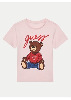 Guess T-Shirt H4BT01 I3Z14 Różowy Regular Fit ze sklepu MODIVO w kategorii Bluzki dziewczęce - zdjęcie 182734409