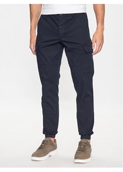 Tommy Hilfiger Joggery Chelsea MW0MW31149 Granatowy Relaxed Fit ze sklepu MODIVO w kategorii Spodnie męskie - zdjęcie 182734889