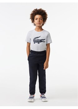 Lacoste Spodnie dresowe XJ2741 Czarny Regular Fit ze sklepu MODIVO w kategorii Spodnie chłopięce - zdjęcie 182738435