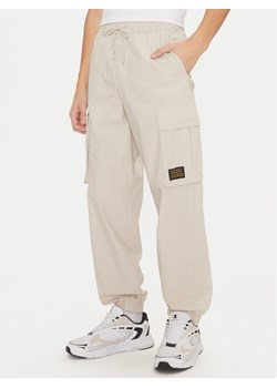 Champion Spodnie dresowe 220415 Écru Loose Fit ze sklepu MODIVO w kategorii Spodnie męskie - zdjęcie 182746275
