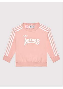 adidas Bluza Graphic HC4559 Różowy Loose Fit ze sklepu MODIVO w kategorii Bluzy dziewczęce - zdjęcie 182765879