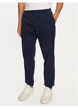 adidas Spodnie dresowe Trefoil Essentials IY2305 Granatowy Regular Fit ze sklepu MODIVO w kategorii Spodnie męskie - zdjęcie 183578336