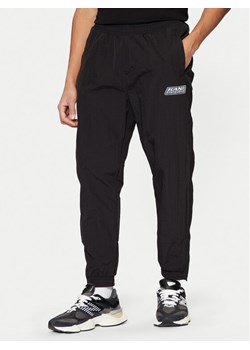 Karl Kani Spodnie dresowe Sport Patch Essential 60030077 Czarny Relaxed Fit ze sklepu MODIVO w kategorii Spodnie męskie - zdjęcie 183689375