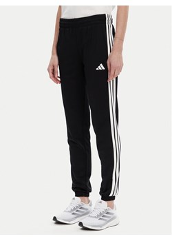 adidas Spodnie dresowe Tricot 3-Stripes JF3383 Czarny Regular Fit ze sklepu MODIVO w kategorii Spodnie damskie - zdjęcie 183737257