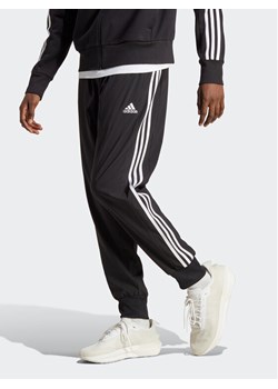 adidas Spodnie dresowe AEROREADY Essentials Tapered Cuff Woven 3-Stripes Joggers IC0041 Czarny Regular Fit ze sklepu MODIVO w kategorii Spodnie męskie - zdjęcie 183885438