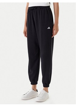 adidas Spodnie dresowe Essentials Small Logo JD7999 Czarny Loose Fit ze sklepu MODIVO w kategorii Spodnie damskie - zdjęcie 184019316