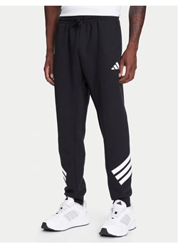 adidas Spodnie dresowe Future Icons 3-Stripes JD4863 Czarny Regular Fit ze sklepu MODIVO w kategorii Spodnie męskie - zdjęcie 184019326