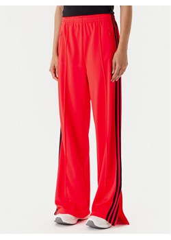 adidas Spodnie dresowe adicolor Classic Firebird JW1227 Pomarańczowy Loose Fit ze sklepu MODIVO w kategorii Spodnie damskie - zdjęcie 184019339