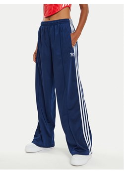 adidas Spodnie dresowe Firebird IL3817 Granatowy Loose Fit ze sklepu MODIVO w kategorii Spodnie damskie - zdjęcie 184215839