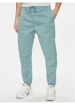 Calvin Klein Performance Spodnie dresowe 00GMF3P613 Niebieski Regular Fit ze sklepu MODIVO w kategorii Spodnie męskie - zdjęcie 184248445