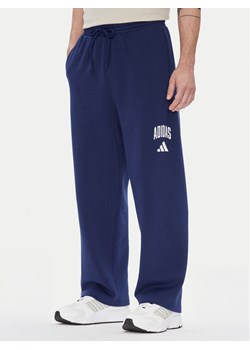 adidas Spodnie dresowe Collegiate JM9179 Niebieski Regular Fit ze sklepu MODIVO w kategorii Spodnie męskie - zdjęcie 184269446