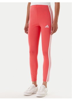 adidas Legginsy Essentials 3-Stripes KE4389 Koralowy Slim Fit ze sklepu MODIVO w kategorii Spodnie damskie - zdjęcie 184562168