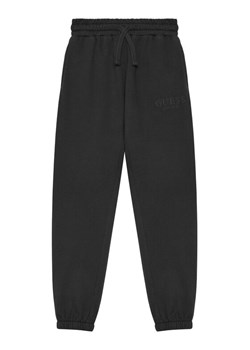 Guess Spodnie dresowe L5YQ19 KAV34 Czarny Regular Fit ze sklepu MODIVO w kategorii Spodnie chłopięce - zdjęcie 184575317