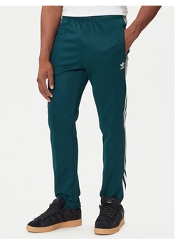 adidas Spodnie dresowe adicolor Classics Beckenbauer JY1275 Zielony Slim Fit ze sklepu MODIVO w kategorii Spodnie męskie - zdjęcie 184657298