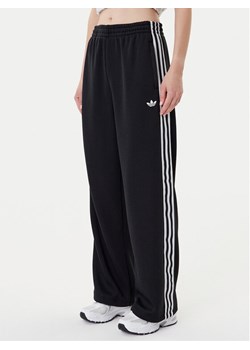adidas Spodnie dresowe adicolor Firebird JV7525 Czarny Regular Fit ze sklepu MODIVO w kategorii Spodnie damskie - zdjęcie 184672755