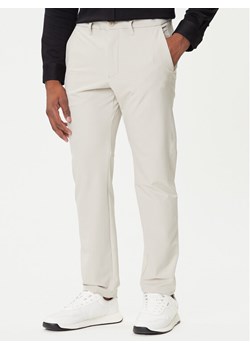 BOSS Spodnie materiałowe T_Commuter 50534303 Beżowy Slim Fit ze sklepu MODIVO w kategorii Spodnie męskie - zdjęcie 184681849