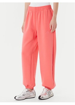 adidas Spodnie dresowe ALL SZN Soft Lux lKD9773 Koralowy Loose Fit ze sklepu MODIVO w kategorii Spodnie damskie - zdjęcie 185039097
