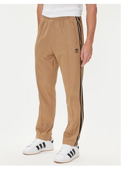 adidas Spodnie dresowe adicolor Classics Beckenbauer JY1276 Beżowy Slim Fit ze sklepu MODIVO w kategorii Spodnie męskie - zdjęcie 185040766