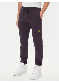 adidas Spodnie dresowe Fortnite JV8015 Fioletowy Regular Fit ze sklepu MODIVO w kategorii Spodnie męskie - zdjęcie 185040787