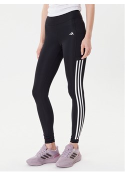 adidas Legginsy Optime 3-Stripes IT9105 Czarny Slim Fit ze sklepu MODIVO w kategorii Spodnie damskie - zdjęcie 185391576