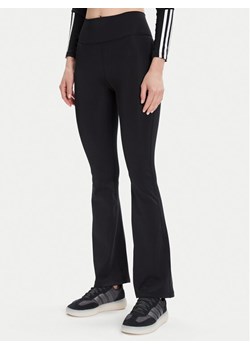 adidas Legginsy All Me Essentials JW7667 Czarny Flare Fit ze sklepu MODIVO w kategorii Spodnie damskie - zdjęcie 185521646