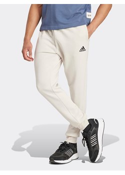 adidas Spodnie dresowe w kolorze kremowym ze sklepu Limango Polska w kategorii Spodnie męskie - zdjęcie 185555499