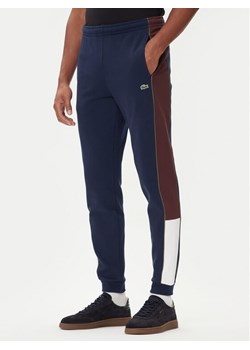 Lacoste Spodnie dresowe XH5923 Granatowy Regular Fit ze sklepu MODIVO w kategorii Spodnie męskie - zdjęcie 185627338