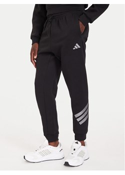 adidas Spodnie dresowe Future Icons 3-Stripes JX1958 Czarny Regular Fit ze sklepu MODIVO w kategorii Spodnie męskie - zdjęcie 186267605