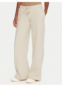 Guess Jeans Spodnie dresowe W5BB04 KC811 Beżowy Wide Leg ze sklepu MODIVO w kategorii Spodnie damskie - zdjęcie 186267707