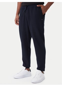 Tommy Hilfiger Spodnie dresowe Terry MW0MW37236 Granatowy Regular Fit ze sklepu MODIVO w kategorii Spodnie męskie - zdjęcie 187259986