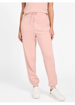 Guess Spodnie materiałowe 179778 Różowy Slim Fit ze sklepu MODIVO w kategorii Spodnie damskie - zdjęcie 187598479