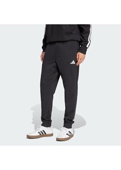 adidas Spodnie dresowe Essentials Feel Cozy JE3854 Czarny Regular Fit ze sklepu MODIVO w kategorii Spodnie męskie - zdjęcie 187670217