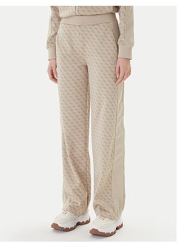 Guess Spodnie dresowe V6RB09 K2042 Beżowy Wide Leg ze sklepu MODIVO w kategorii Spodnie damskie - zdjęcie 187681077
