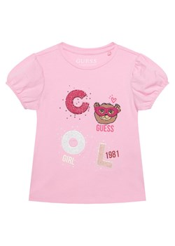 Guess T-Shirt K6RI05 K6YW4 Różowy Regular Fit ze sklepu MODIVO w kategorii Bluzki dziewczęce - zdjęcie 187747906