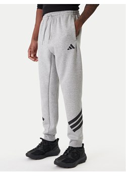 adidas Spodnie dresowe Future Icons 3-Stripes JD4867 Szary Regular Fit ze sklepu MODIVO w kategorii Spodnie męskie - zdjęcie 187828045