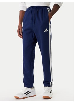 adidas Spodnie dresowe Essentials 3-Stripes JE6334 Granatowy Regular Fit ze sklepu MODIVO w kategorii Spodnie męskie - zdjęcie 187831008
