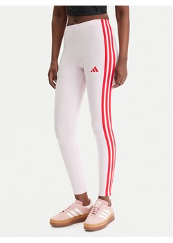 adidas Legginsy Essentials 3-Stripes KC5180 Różowy Slim Fit ze sklepu MODIVO w kategorii Spodnie damskie - zdjęcie 188007678