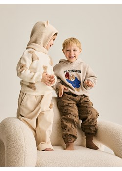 Reserved - Sztruksowe spodnie z aplikacją - kremowy ze sklepu Reserved w kategorii Spodnie dziewczęce - zdjęcie 188093519