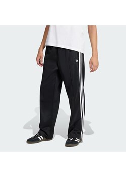 adidas Spodnie dresowe adicolor KE3501 Czarny Loose Fit ze sklepu MODIVO w kategorii Spodnie męskie - zdjęcie 188424758