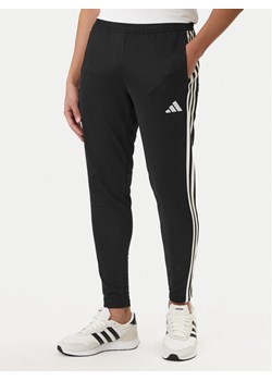 adidas Spodnie dresowe Tiro 25 Essentials Training JD0442 Czarny Regular Fit ze sklepu MODIVO w kategorii Spodnie męskie - zdjęcie 188476878