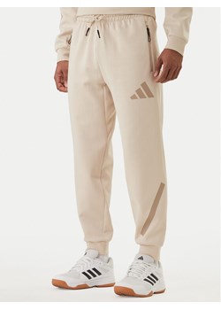 adidas Spodnie dresowe Z.N.E. KE4684 Beżowy Regular Fit ze sklepu MODIVO w kategorii Spodnie męskie - zdjęcie 188513298