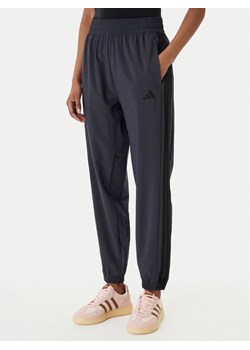 adidas Spodnie dresowe Train Essentials 3-Stripes Woven KC5496 Czarny Regular Fit ze sklepu MODIVO w kategorii Spodnie damskie - zdjęcie 188515656
